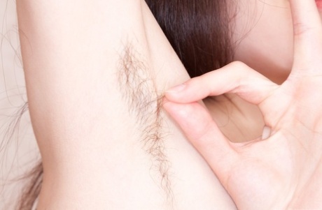 Amateur Maia exhibits her tiny tits and hairy armpits before brushing off the excess with her bushiness.