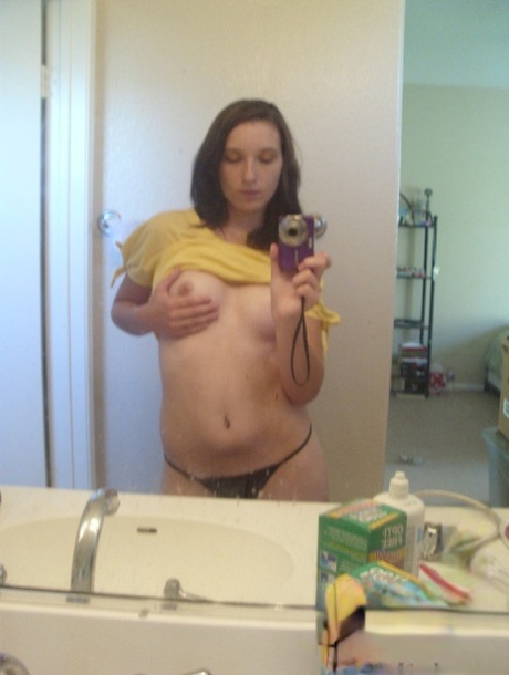 Amateur teen babe Casey posing topless in her black g-string panties