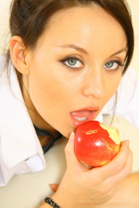 In an apple-biting pose, Lusty Carla strips off her clothes and wears only knee high socks for a photo.