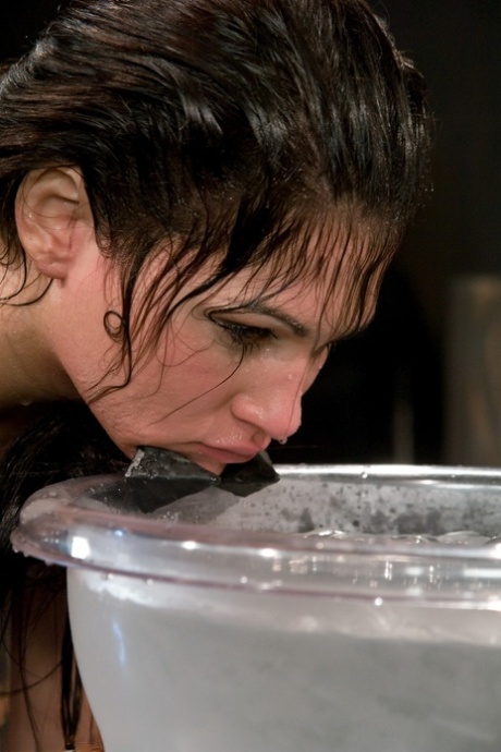 Miss Jade Indica has her anal flexed while holding a bucket of water over her head.