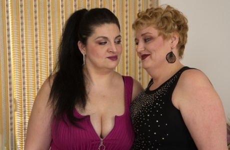 BBW amateurs Lucille and Mily looking glamorous in their dresses.