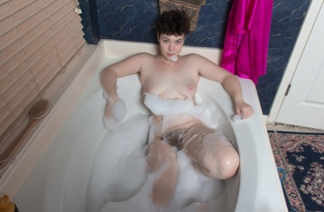 Chubby Dmitri Vosche is seen in a nude after washing off her hairy moustache while bathing in the tub.
