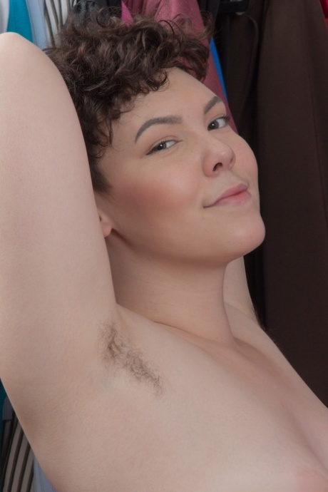 Smiling naked, Dmitri Vosche is seen playing with her hairy snatcher.