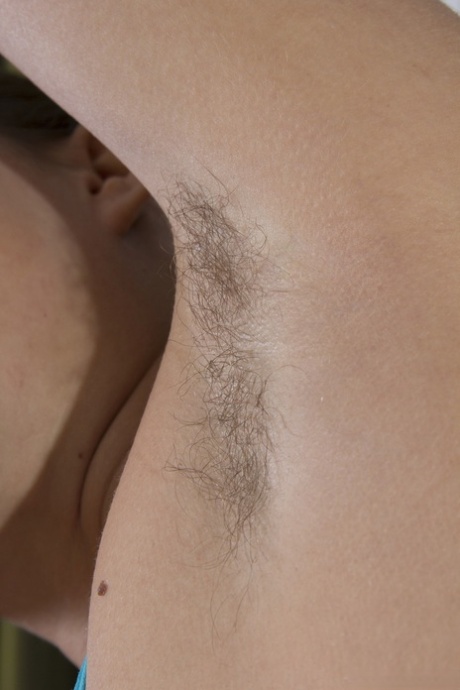 A hairy vagina is exposed and the hair is spread out while amateur brunette Lita exercises.