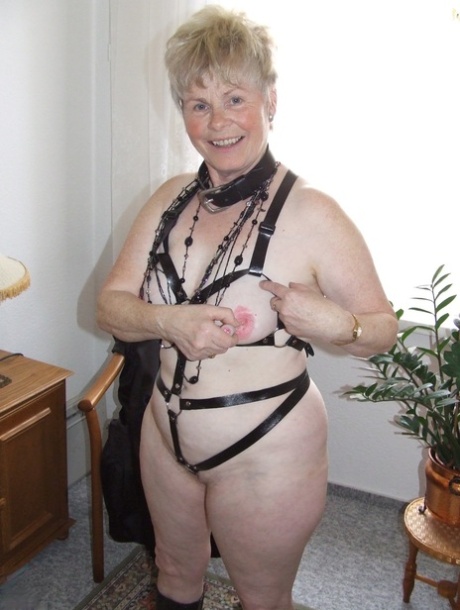 To go nude, an older BBW with short spiky hair goes off the dresser's lingerie and fetish gear.