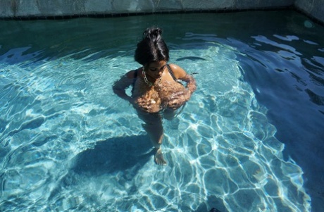 In the pool, a heavily endowed Maserati XXX with big breasts is floating in front of her.