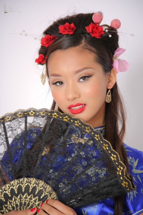 In her svelte and attractive form, Alina Li, a young Asian, leaves the traditional attire on display.
