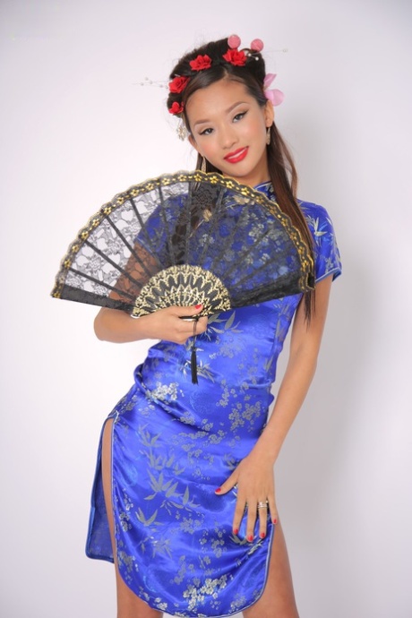 Exhibiting her slim physique, Alina Li is a stunning young Asian who dons traditional attire to showcase her body shape.