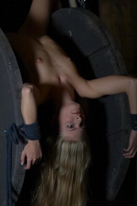 Cayenne Klein, who was helplessly battered, participated in an outdoor inverted-suspension BDSM action.