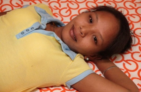 Sweet Filipina Danica exhibits her delicious pussy and tiny tits while unclothing.