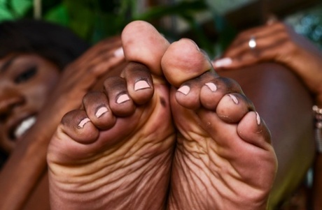 Athletic black model shows off the souls of her feet while getting naked