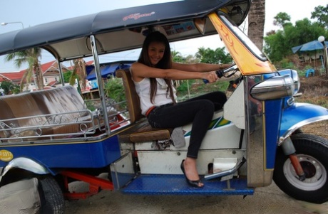 A bed-ridden sweet Thai girl exposes her tight jeans in the air while wearing a bra.