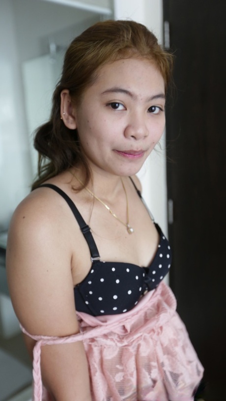 In Thailand, Mint is a petite girl who exposes her clothes and then displays them to show off her tiny hairy pussy.