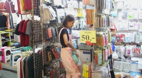 The slim Puy, a Thai girl with thin breasts, is convinced to loosen her small boobs from her overalls.
