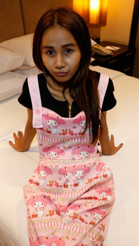 Puy, a slim girl from Thailand, is convinced to release her small breasts from her overalls.