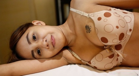 Despite her size, Puy, a slim Thai girl, is persuaded to let go of her small breasts that she has hidden in her chest.