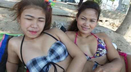 Delicious teenage Thai babes Bee and Miaw posing at the beach in hot bikinis