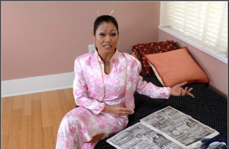 The sexy Asian MILF Charina Lee displays her juggles and receives her tattoo.