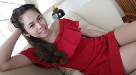 Prior to her modeling gigs, an adorable Thai model models herself in a red dress.