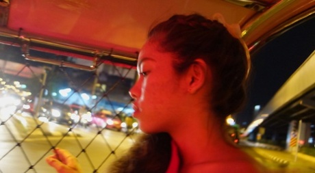 A Thai model, who is a first timer, models herself in her red dress before heading out to perform.