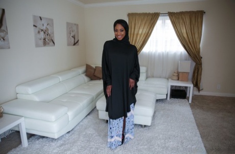 The beautiful Lala Ivey wears an ebony hijab and is spread with her legs, showing off her medium tits and beauty.