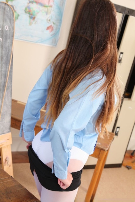 Adorable student: Aimee undresses in the classroom to be photographed wearing white pantyhose.