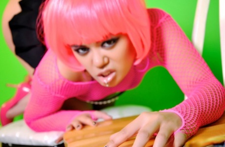 The activity of Annie Cruz was depicted by a pink-haired hottie holding her vagina and hands while posing in a chair.