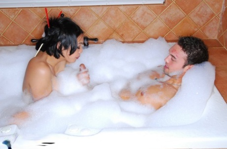 Steamy hand sex: Asian bubble bath masseuse Mika Tan is seen here giving the "rubber-lipped" extrication of her penises in front of her.