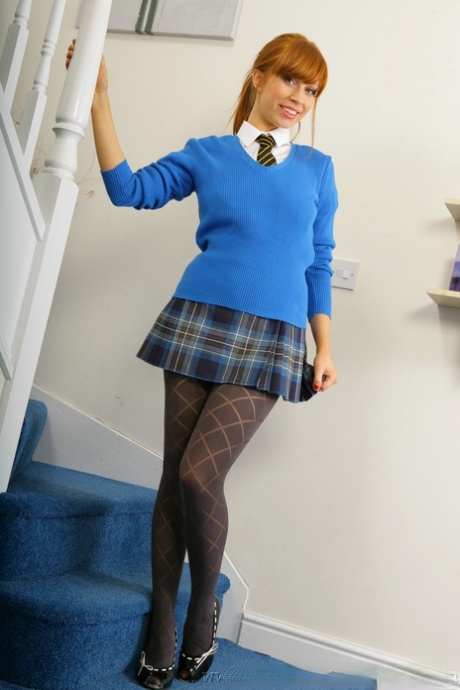 The innocent Alexandra schoolgirl displays her stunning looks on the stairs.