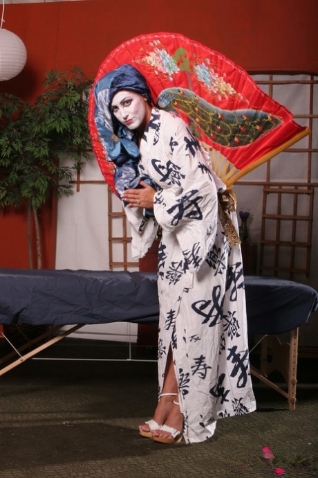 Young Asian Keanni Lei takes a solo stage without clothes and poses in her short skirt.
