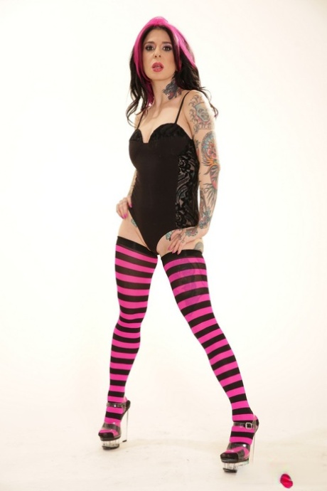 Hot tattooed punk slut Joanna Angel poses in her black & purple stockings