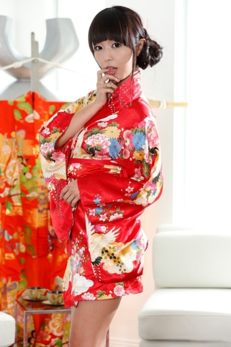 Wearing her kimono, Marica Hase, a Japanese brunette, shows off her good looks.