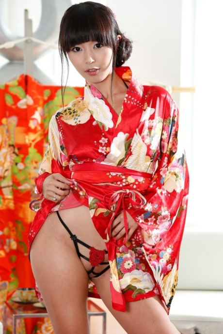 In her kimono, Marica Hase, a Japanese woman, removes herself to show off her beauty.