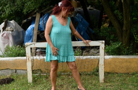 Redhead Granny Livia Lifts Her Blue Dress Up And Reveals Big Natural Tits