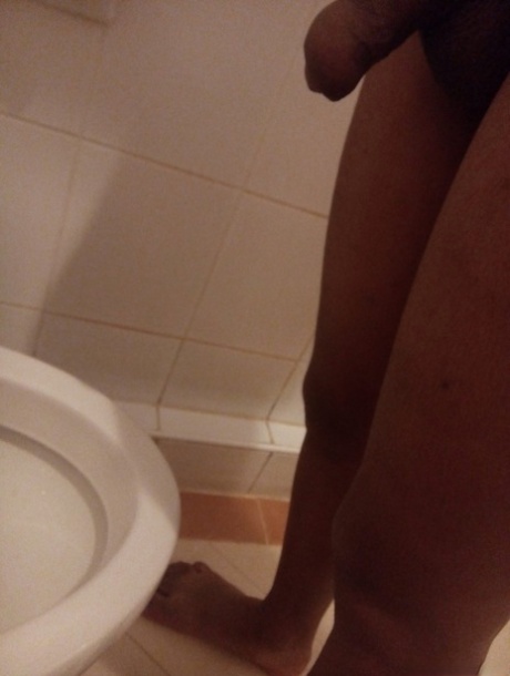 Transgender Chick Is Pissing In The Toilet While Being Filmed In Close Up