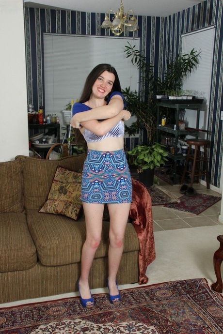 The long-haired brunette Gabby Smith plays with her new sex toy on the couch while lounging around.