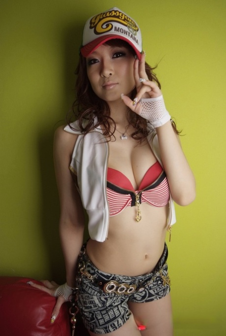 Amateur swimmer Misa Kikouden, a beautiful Japanese girl dressed in an American bikini, poses for pictures by the wall.