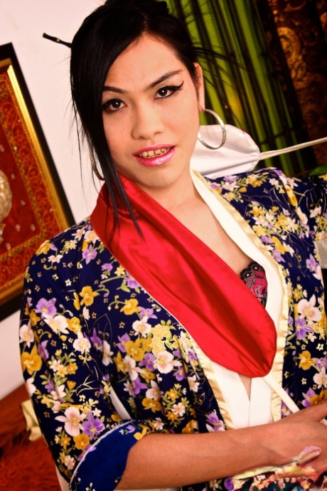 An Asian shemale, Natti removes her kimono and displays an erect penis with ease.