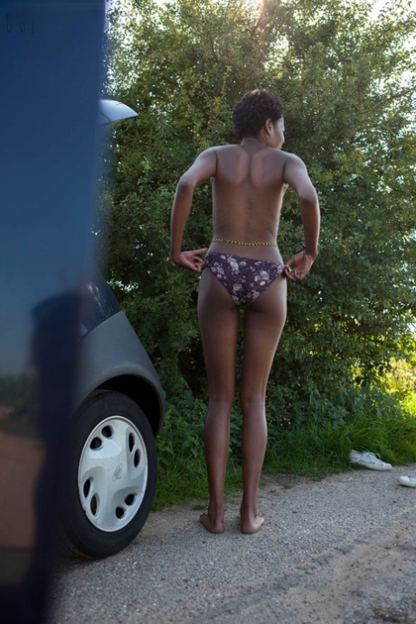 Naked Black Female With Long Legs Gets Dressed By The Side Of The Rode