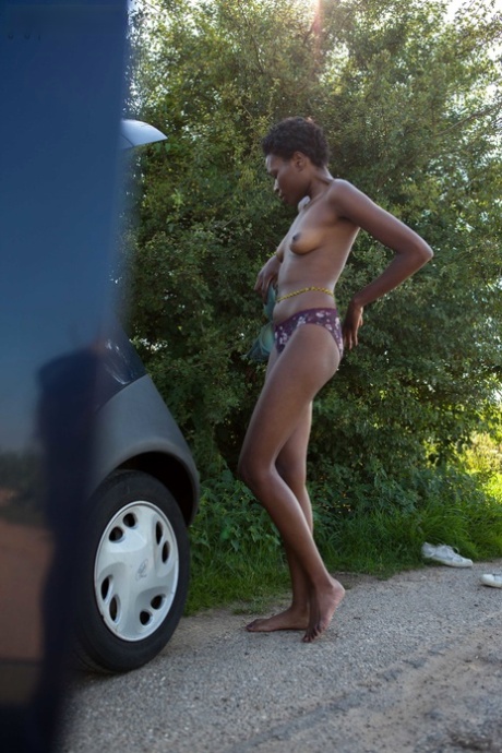 Naked Black Female With Long Legs Gets Dressed By The Side Of The Rode