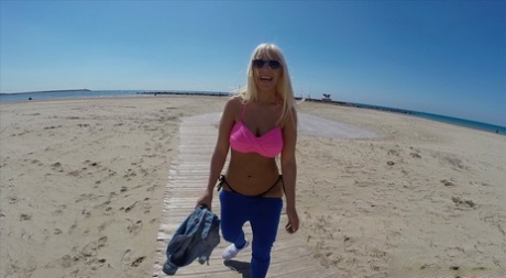 The beach-ready blonde, Blondie Fesser, flaunts her bulging phallus with confidence.