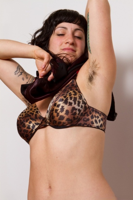 Stacey Stax, a black-haired temptress, exposes her beardy arm and displays furry twats.