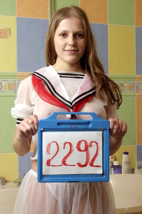 A cute schoolgirl named Molly C enjoys her shower experience with stick-on dildos.