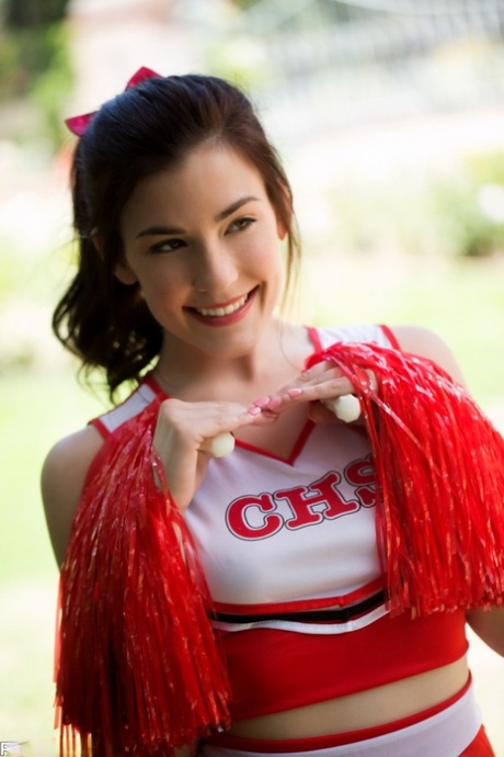 Cute cheerleader Jenna Reid doffs her uniform and exposes her small tits