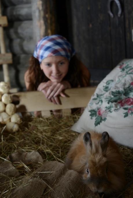 Young brunette girl tends to her farm animals without any clothes on #12