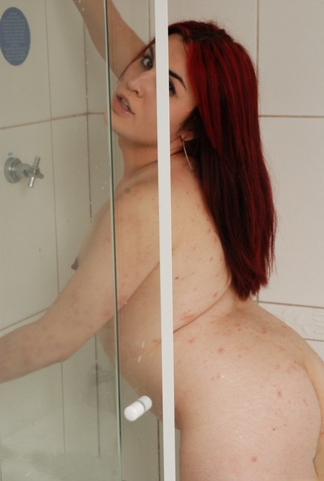 During her showers, Anita Volgato engages in masturbation while wearing stockings with redheaded shemale hair.