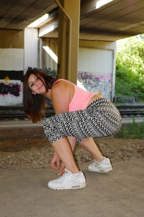 During stretching exercises, July Johnson from Germany displays her juicy pants and ass while hiding behind clothes.