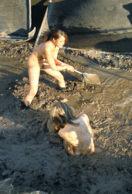 Blonde MILF Tyla Wynn participates in a 2 against 1 naked lezdom session in the mud.