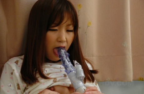 With her preferred vibrator, Shino Tanaka, a horny Asian female, masturbates while stripping.