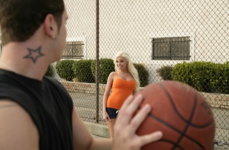 Super sexy pornstar with big tits Britney Amber shows cleavage shooting hoops